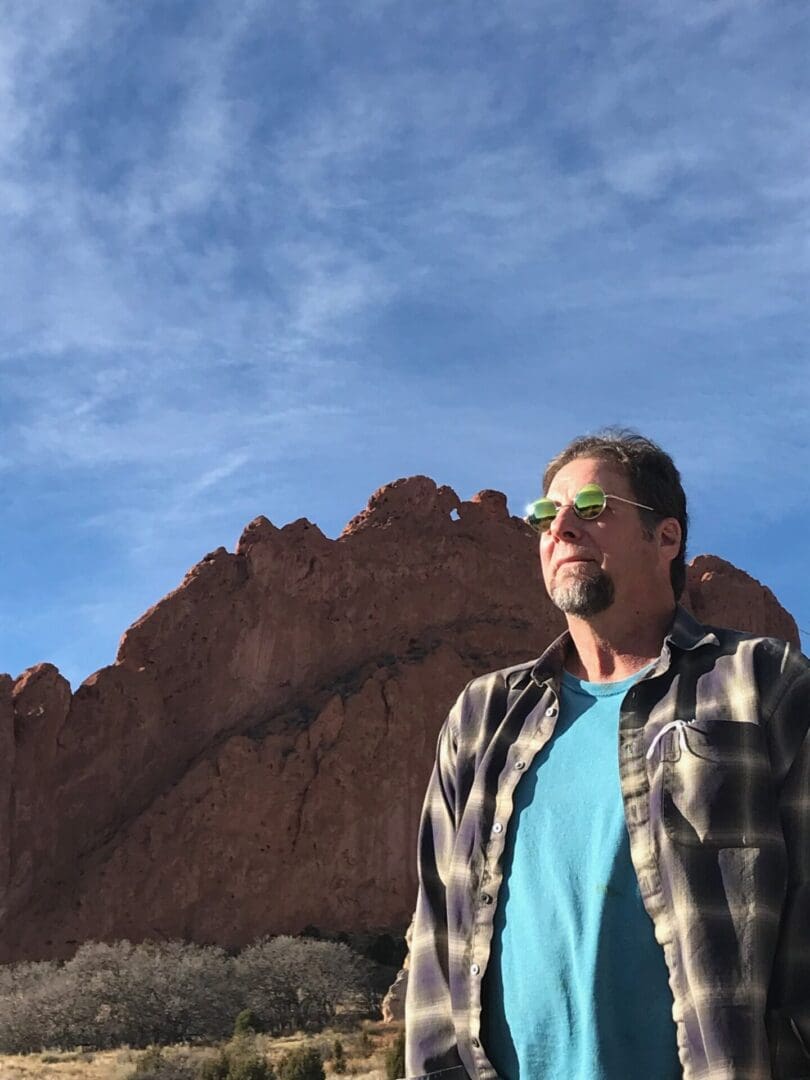 A man standing in front of some mountains